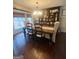 Formal dining room with a dark wood table, decorative hutch, chandelier, and window with natural light at 848 Still Rd, Lawrenceville, GA 30045