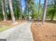 A long driveway winds through the trees up to a charming home at 848 Still Rd, Lawrenceville, GA 30045