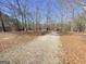 Long driveway leading to property, surrounded by trees and natural foliage at 848 Still Rd, Lawrenceville, GA 30045