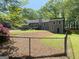 A well-maintained home and landscaped backyard are framed by a black chain-link fence at 848 Still Rd, Lawrenceville, GA 30045