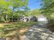 Charming single-story home with attached garage and well-maintained lawn surrounded by mature trees at 848 Still Rd, Lawrenceville, GA 30045