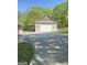 A detached garage with a white door sits at the end of a concrete driveway at 848 Still Rd, Lawrenceville, GA 30045