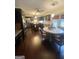 Spacious kitchen with black cabinetry, an island, stainless steel appliances, and an adjacent dining area at 848 Still Rd, Lawrenceville, GA 30045