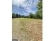A large grassy field with trees provides an ideal setting for recreation at 848 Still Rd, Lawrenceville, GA 30045
