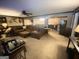 Spacious living room with brown sectional sofa, ceiling fan, and decorative animal heads at 848 Still Rd, Lawrenceville, GA 30045