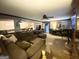 Open living room with a large sectional, dining area, and a view of the kitchen at 848 Still Rd, Lawrenceville, GA 30045