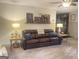 Inviting living room with a comfortable leather sofa, decorative pillows, and stylish side tables with lamps at 848 Still Rd, Lawrenceville, GA 30045