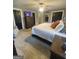 Spacious main bedroom features dark-toned furniture, carpeted floors, and plenty of room at 848 Still Rd, Lawrenceville, GA 30045