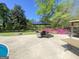 A comfortable seating area is set on the patio amongst flowers at 848 Still Rd, Lawrenceville, GA 30045