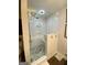 Modern bathroom with a frameless glass shower, white subway tile and pebble stone flooring at 848 Still Rd, Lawrenceville, GA 30045