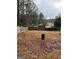 Fenced backyard with mature trees provides a private and secure outdoor space for recreation at 5865 Vernier Dr, Atlanta, GA 30349