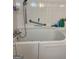 Accessible white bathtub with safety bar and handheld shower head at 5865 Vernier Dr, Atlanta, GA 30349