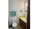 Bathroom featuring a toilet, sink with yellow countertop, and brown cabinets at 5865 Vernier Dr, Atlanta, GA 30349