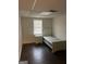 This cozy bedroom features a bed, nightstand, and window at 5865 Vernier Dr, Atlanta, GA 30349