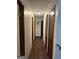 Hallway with multiple wooden doors and neutral walls provides access to various rooms in the house at 5865 Vernier Dr, Atlanta, GA 30349