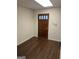 This room features a dark wooden door and dark laminate floors at 5865 Vernier Dr, Atlanta, GA 30349