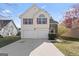 Charming two-story home with a well-manicured lawn and attached two-car garage at 11789 Registry Blvd, Hampton, GA 30228