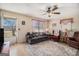 Cozy living room featuring neutral walls, ceiling fan and large patterned rug at 143 Teamon Rd, Hampton, GA 30228