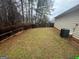 Backyard with lawn, fence, and treeline at 165 Lakeside Pt, Covington, GA 30016