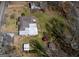 Aerial view of the property featuring a house with a light-colored roof and multiple outbuildings at 123 Cowan Rd, Covington, GA 30016