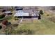 Bird's eye view showing the house, various sheds, and partially fenced yard at 123 Cowan Rd, Covington, GA 30016