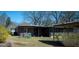 Back exterior showcasing the covered, screened-in porch with tidy landscaping at 123 Cowan Rd, Covington, GA 30016