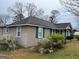 Spacious backyard featuring a utility building, mature trees and landscaping at 123 Cowan Rd, Covington, GA 30016