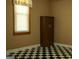 Cozy bedroom with a checkered floor, window with blinds, and a built-in closet at 123 Cowan Rd, Covington, GA 30016