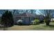 An exterior view of a home with neutral colors and a manicured lawn in a garden setting at 123 Cowan Rd, Covington, GA 30016