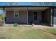 An outdoor patio adjacent to the backyard features a metal awning and a path to the grass at 123 Cowan Rd, Covington, GA 30016