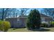 An exterior view with an adjacent bush full of pink and white flowers in a well maintained yard at 123 Cowan Rd, Covington, GA 30016