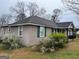 A cozy, single-story home with green shutters and well-kept landscaping at 123 Cowan Rd, Covington, GA 30016