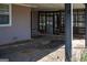 A view of a screened in back porch with a concrete parking area and metal support beam at 123 Cowan Rd, Covington, GA 30016