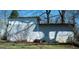 A side exterior shot of a home with modern architecture and minimalistic landscaping at 123 Cowan Rd, Covington, GA 30016