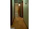 Hallway with wood flooring that leads to multiple rooms with contrasting flooring at 123 Cowan Rd, Covington, GA 30016