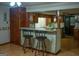 Eat-in kitchen featuring a breakfast bar with chairs, wood cabinets, and laminate countertops at 123 Cowan Rd, Covington, GA 30016