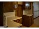 Kitchen with wooden cabinets, light countertops, and a window at 123 Cowan Rd, Covington, GA 30016
