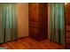 Main bedroom with wood floors, large built-in wardrobe, and curtains at 123 Cowan Rd, Covington, GA 30016