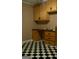 Small office area featuring a checkered floor, wooden cabinets, and a built-in desk at 123 Cowan Rd, Covington, GA 30016