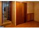 A bedroom with wood laminate flooring features built-in cabinets and adjacent access to other rooms at 123 Cowan Rd, Covington, GA 30016