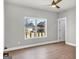 Light-filled bedroom featuring hardwood floors, a ceiling fan, a window view of the neighborhood, and a neutral color palette at 209 Langshire Dr, Mcdonough, GA 30253