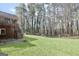 Large, green backyard featuring a wooden deck with stairs leading down to the well-maintained lawn at 3075 Wood Valley Dr, Mcdonough, GA 30253