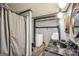 Rustic bathroom with a shower, black marble sink, stacked washer and dryer, and wooden ceiling at 3075 Wood Valley Dr, Mcdonough, GA 30253