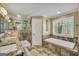 Bathroom with granite countertops, soaking tub, and a glass-enclosed shower at 3075 Wood Valley Dr, Mcdonough, GA 30253