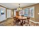 Sunny dining room featuring a wood table, chandelier, and bay window at 3075 Wood Valley Dr, Mcdonough, GA 30253