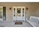 Inviting front porch with a swing, a wreath on the door, and traditional design elements at 3075 Wood Valley Dr, Mcdonough, GA 30253