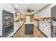 Spacious kitchen featuring a central island, stainless steel appliances, granite countertops and white cabinetry at 3075 Wood Valley Dr, Mcdonough, GA 30253