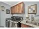 Modern laundry room with stainless steel washer and dryer, ample cabinet space, and granite countertops at 3075 Wood Valley Dr, Mcdonough, GA 30253