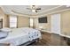 Spacious main bedroom with dark wood floors, trey ceiling, and large windows at 3075 Wood Valley Dr, Mcdonough, GA 30253