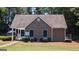 A pool house with a brown exterior, green shutters, and well-manicured landscaping at 3075 Wood Valley Dr, Mcdonough, GA 30253